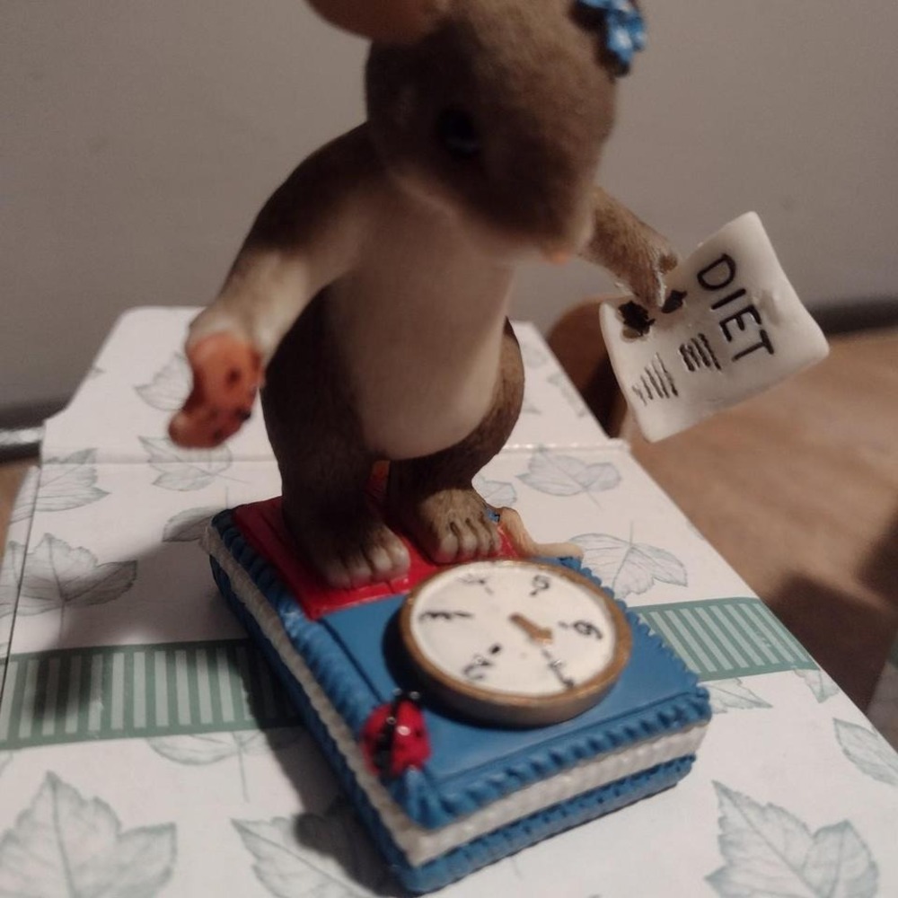 Charming Tales Just Weight figuring. Mouse on a scale eating a cookie.